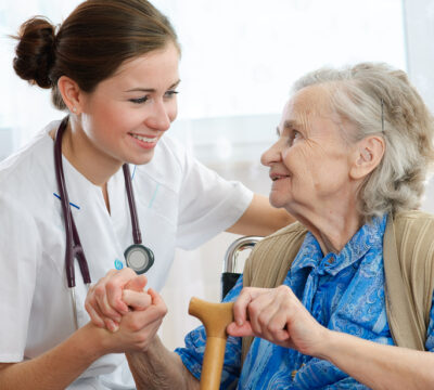 Senior woman with her doctor or caregiver
