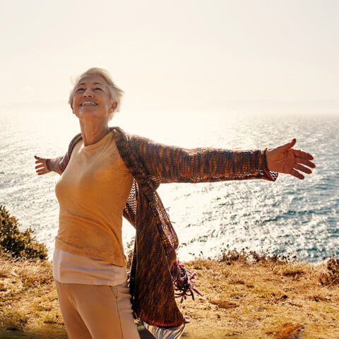 happy woman by the ocean
